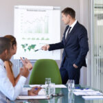 a businessman giving a sustainability-related presentation to co-workers in an office
