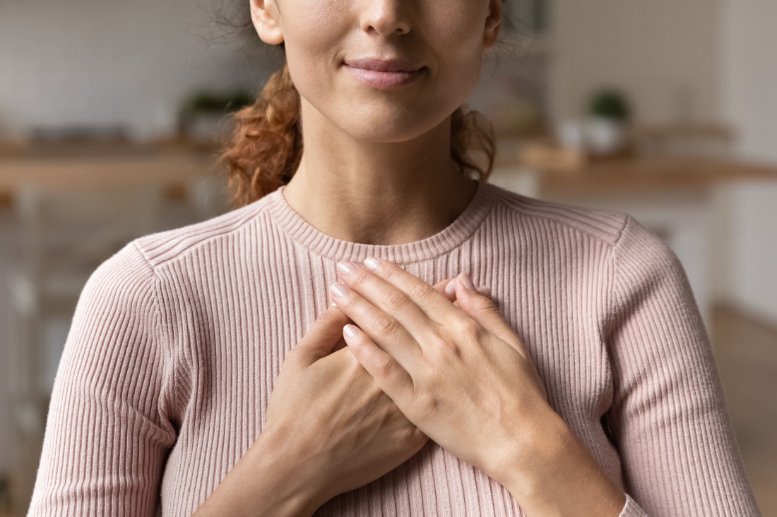 A woman with her hands over her heart
