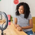 A young woman records a TikTok video