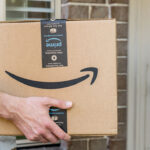 Amazon prime big huge box delivered to a front door of residential building