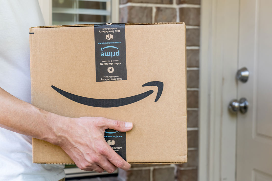 Amazon prime big huge box delivered to a front door of residential building