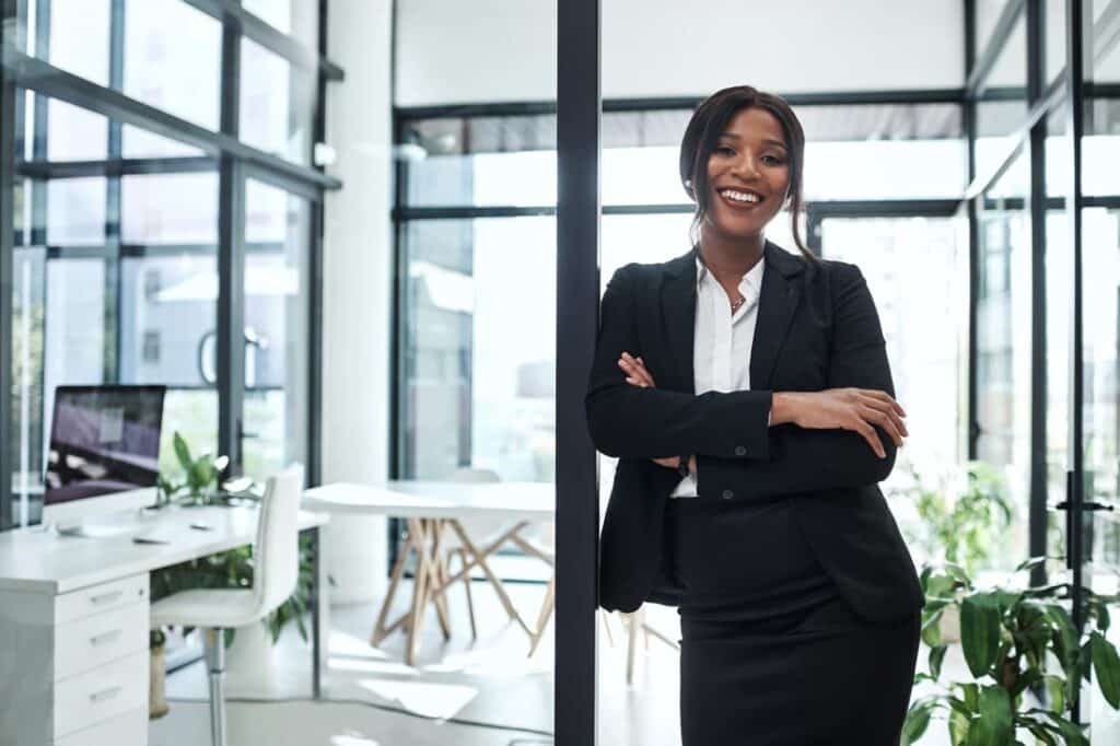 Smiling successful entrepreneur standing in a doorway