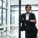 Smiling successful entrepreneur standing in a doorway