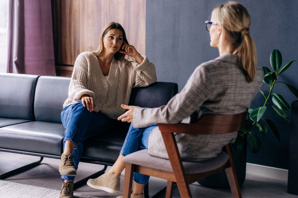 A young woman in a consultation with a professional listens to advice