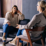 A young woman in a consultation with a professional listens to advice