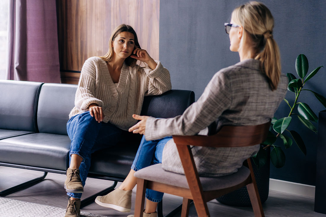 A young woman in a consultation with a professional listens to advice