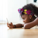 African American woman sending a text message on a mobile phone