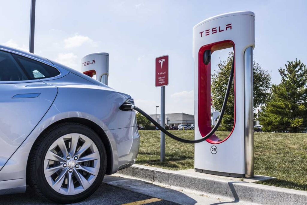 Electric vehicle charging at a Tesla station