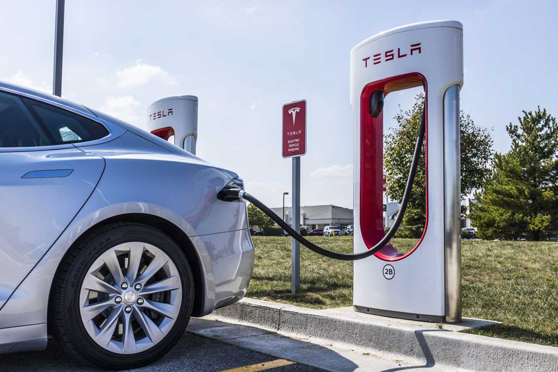 Electric vehicle charging at a Tesla station