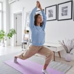 a woman doing yoga in her living room at home
