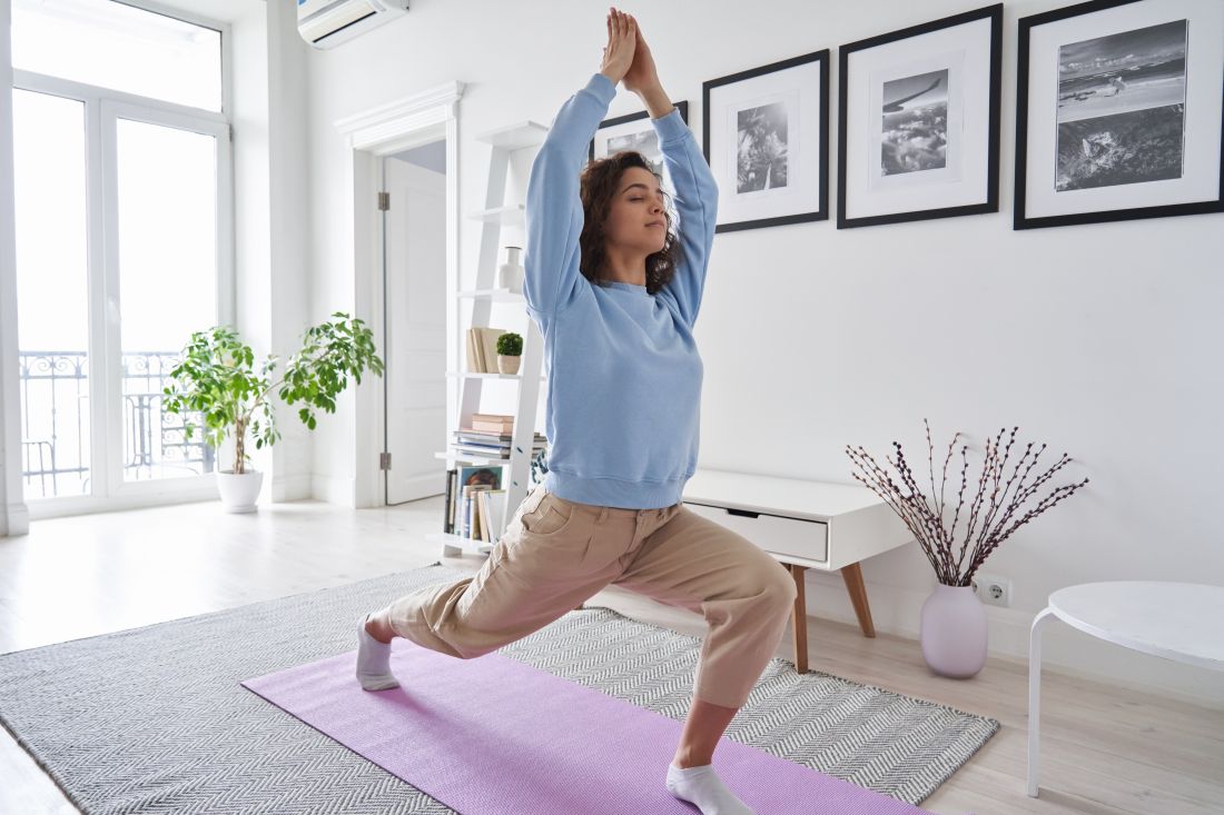 a woman doing yoga in her living room at home