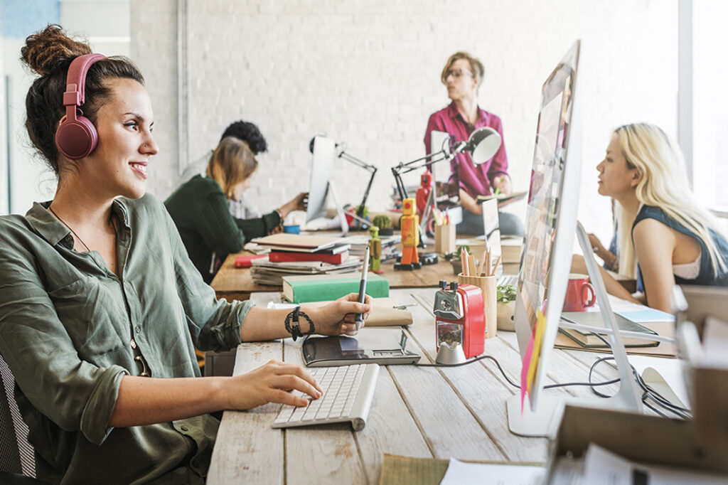 A female employee listens to music in the workplace