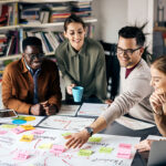 High angle view of young happy freelances brainstorming while working on new business