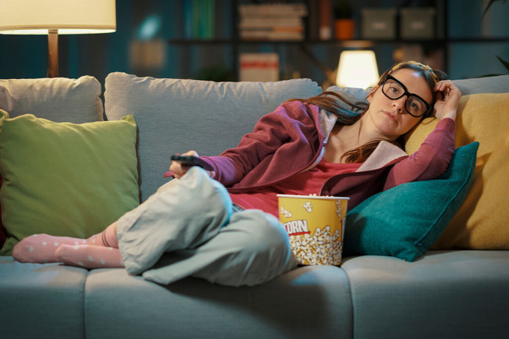 woman on couch watching tv