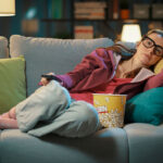woman on couch watching tv