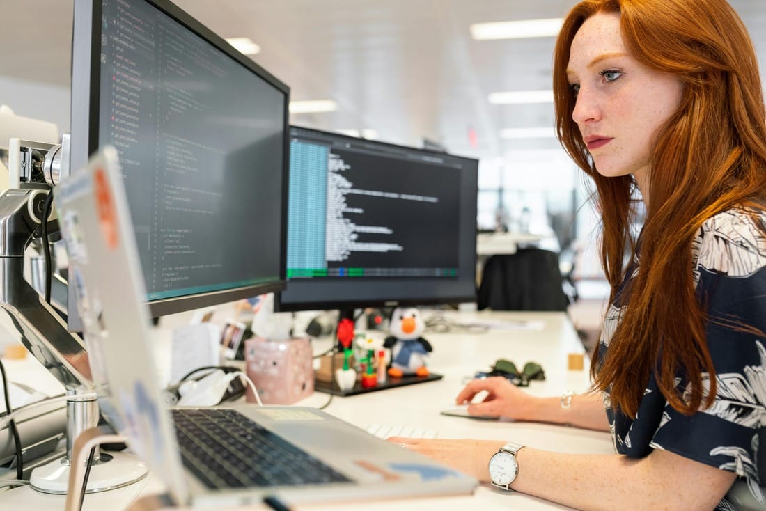 a woman sitting at a desk using a computer