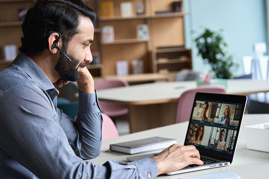 A business leader participates in a meeting using an AI assistant