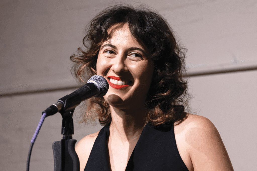 Jemma Rose Brown at a microphone