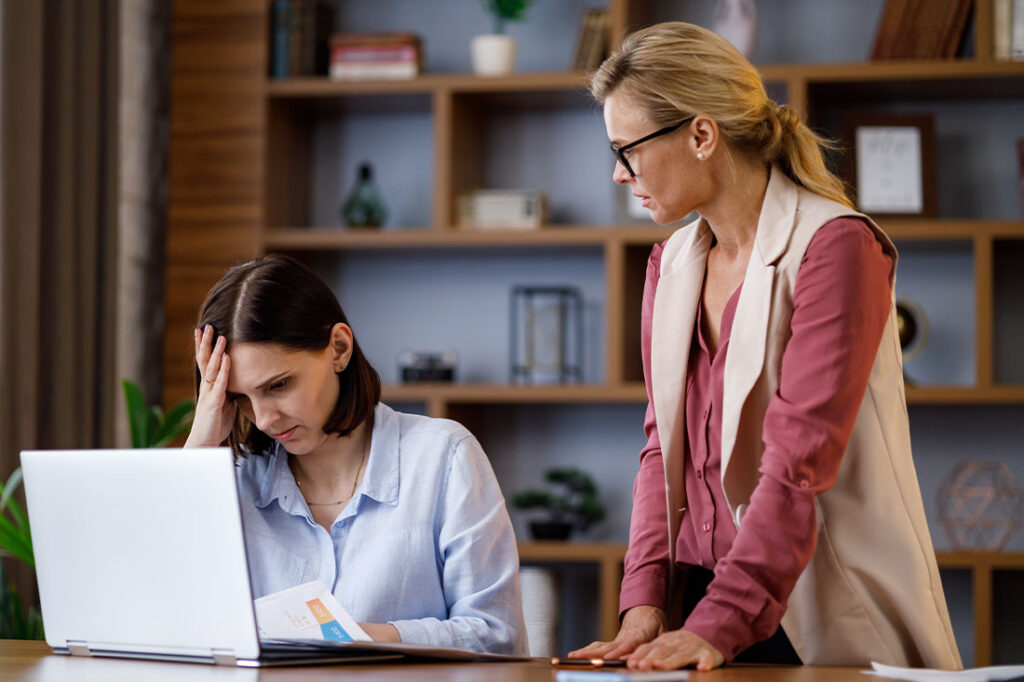 Angry boss scolding office worker