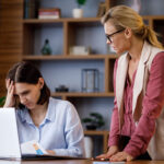 Angry boss scolding office worker