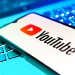 Smartphone on surface showing Youtube logo