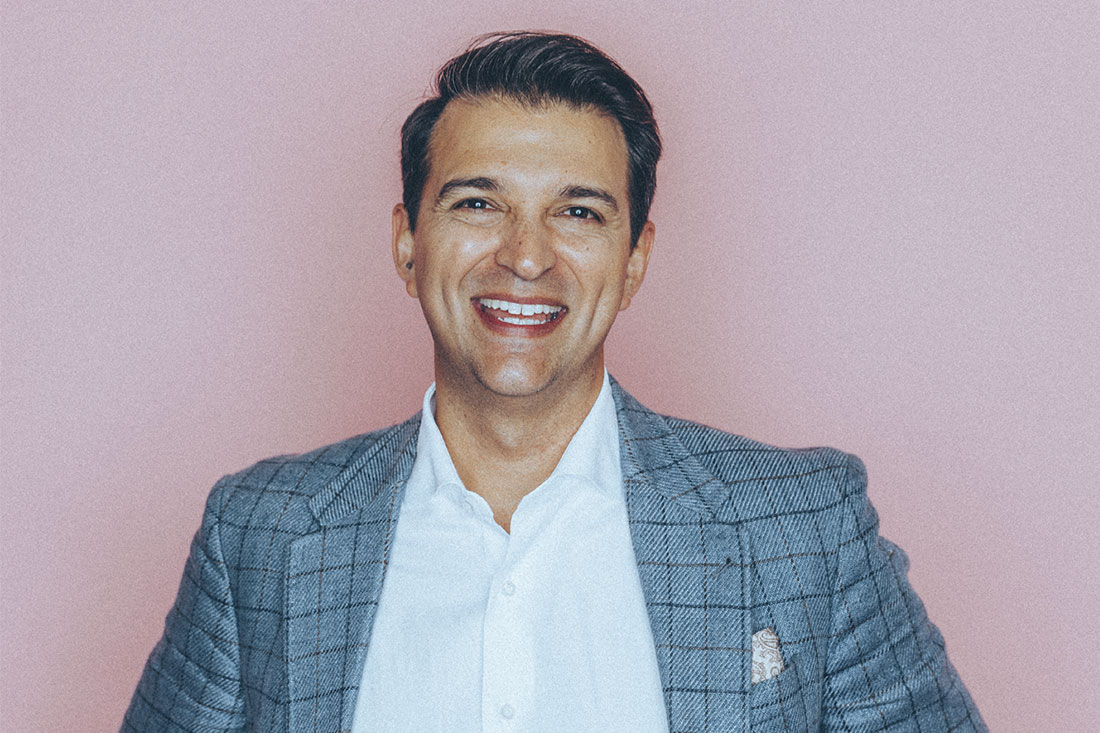 Rory Vaden headshot with pink backdrop