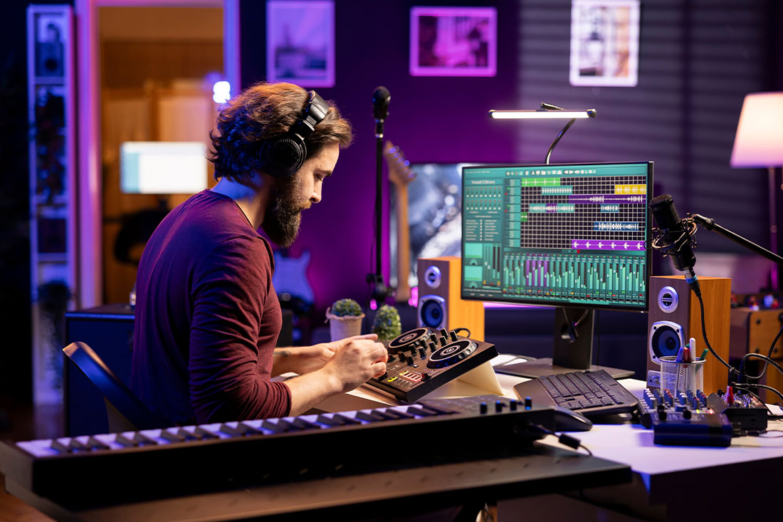 Young artist mixing and mastering tunes on professional console