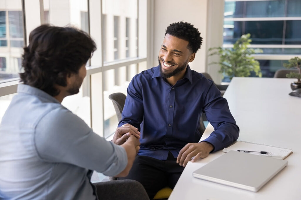 businessman shaking hands with businessman for negotiating in corporate office