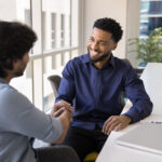 businessman shaking hands with businessman for negotiating in corporate office