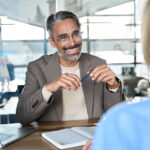 happy businessman speaking with employee