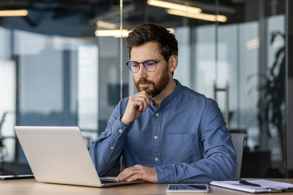 young business man works in the office with a laptop