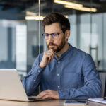 young business man works in the office with a laptop