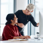 businesswomen and mentor with computer