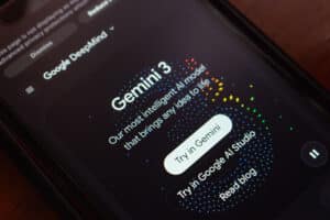 Close-up of Google DeepMind Gemini 3 promotional website with vibrant dotted graphics and interactive buttons.
