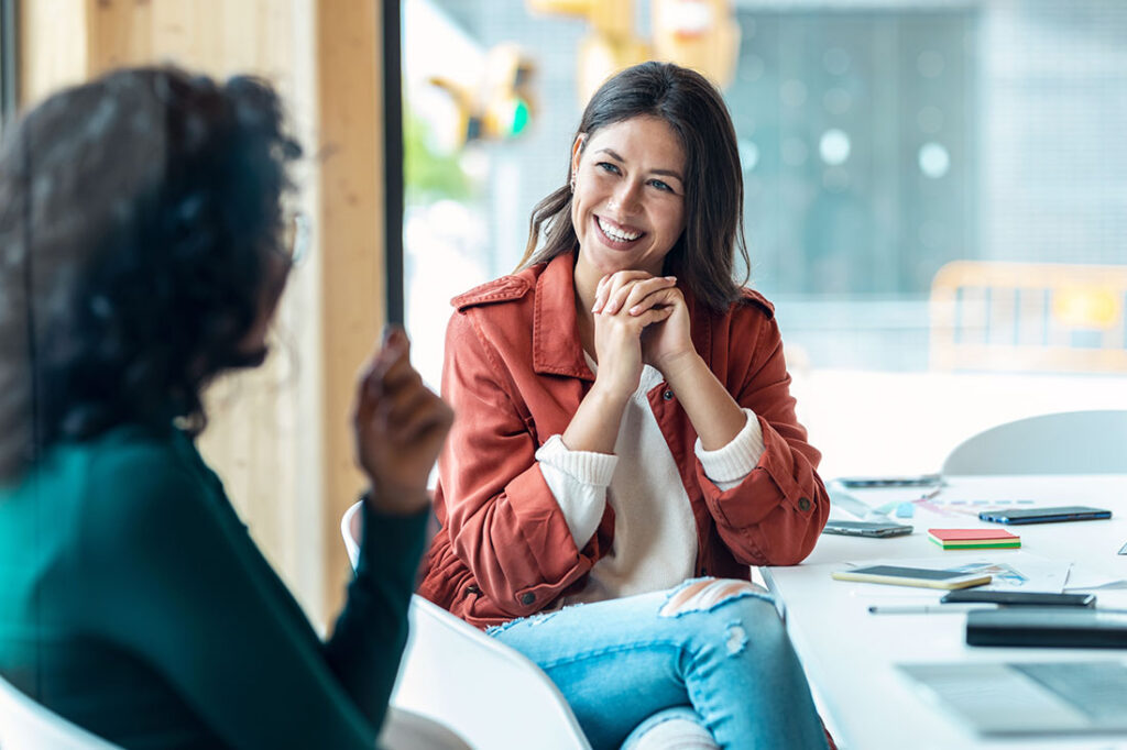 Shot of smart business people working together with laptop while talking