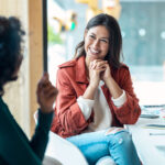 Shot of smart business people working together with laptop while talking